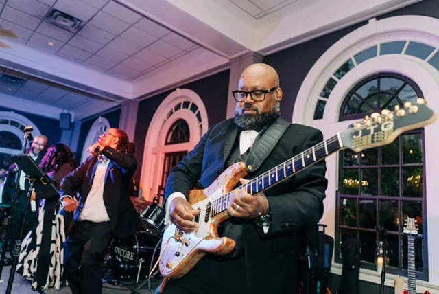 Encore of Lexington's bassist performing live in black tie